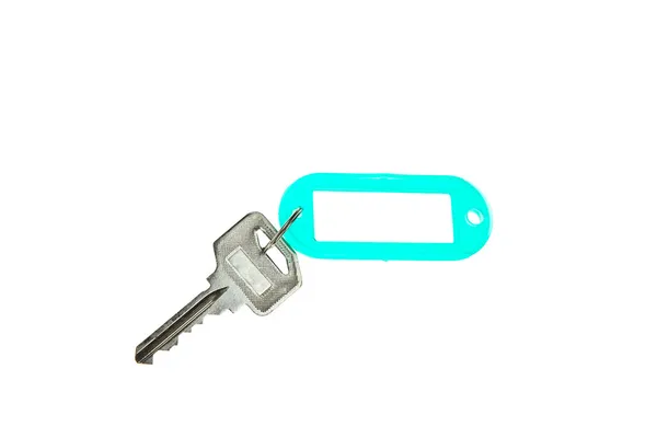 Clave con etiqueta en blanco aislada sobre fondo blanco — Foto de Stock