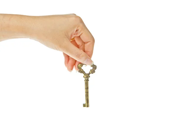 Old golden key with hand isolated on white background — Stock Photo, Image