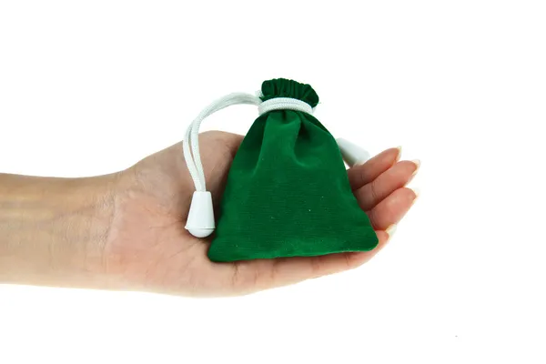 Bolsa de terciopelo verde con mano aislada sobre fondo blanco — Foto de Stock