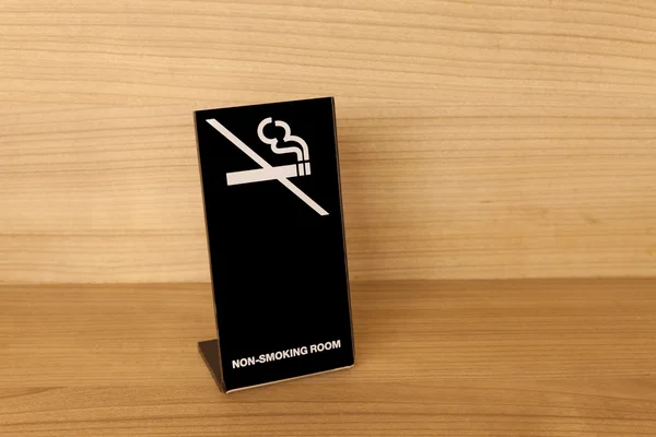 Ahşap masa üzerinde hiç Sigara İçilmez işareti — Stok fotoğraf