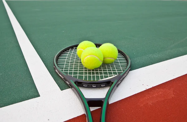 Pista de tenis con pelotas y raqueta — Foto de Stock