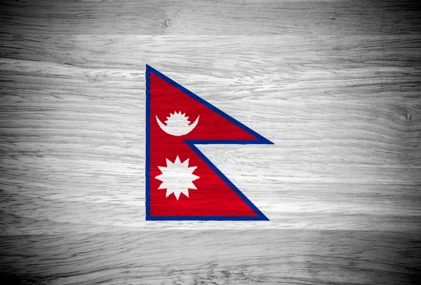 Bandera de Nepal sobre textura de madera — Foto de Stock