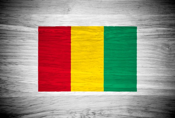 Guinea flag on wood texture — Stock Photo, Image