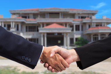 Businessman handshake for real estate business clipart