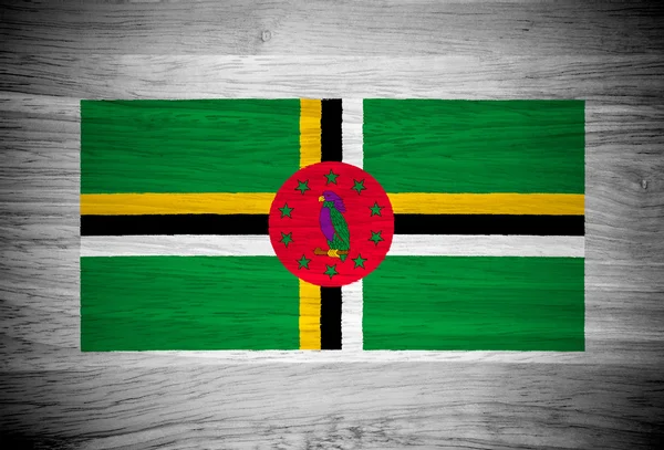 Dominica flag on wood texture — Stock Photo, Image