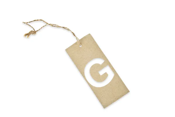 Brown paper tag with letter G cut — Stock Photo, Image