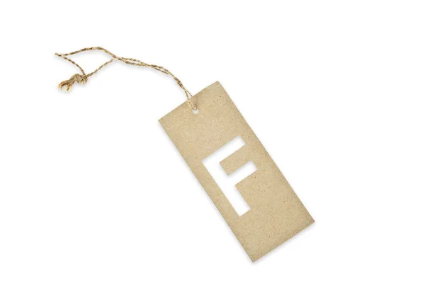 Brown paper tag with letter F cut — Stock Photo, Image