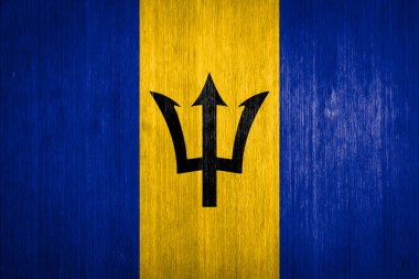 Barbados Flag on wood background clipart