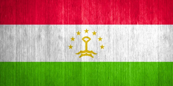 Tajikistan Flag on wood background — Stock Photo, Image