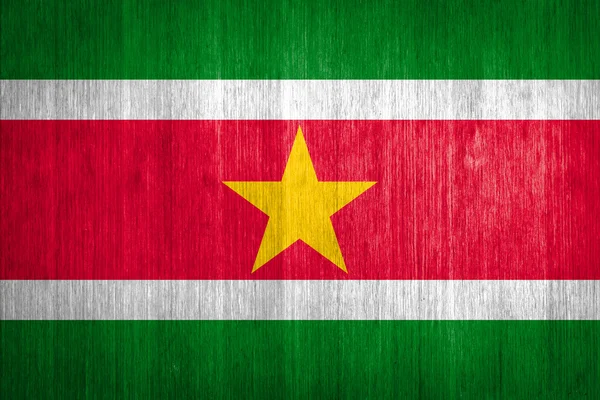 Suriname Flag on wood background — Stock fotografie