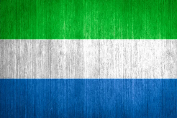 Sierra Leone Flag on wood background — Stock Photo, Image