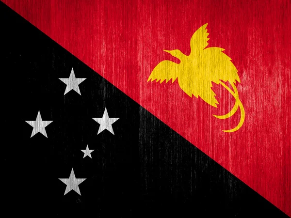 Papua New Guinea Flag on wood background — Stock Photo, Image