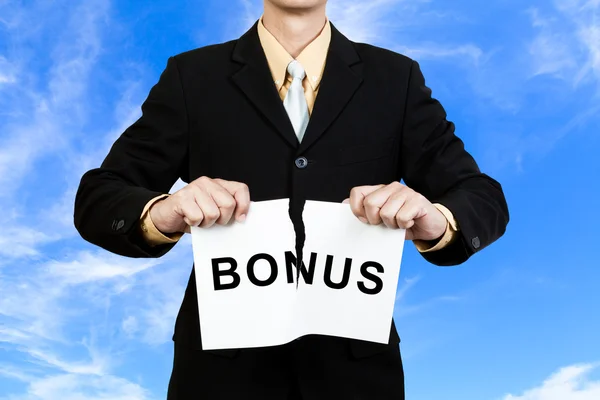 Podnikatel roztrhat papír s slovo bonus — Stock fotografie