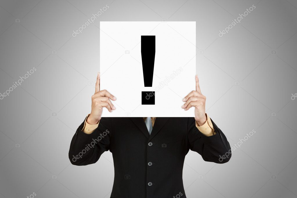 Businessman show exclamation mark on paper board
