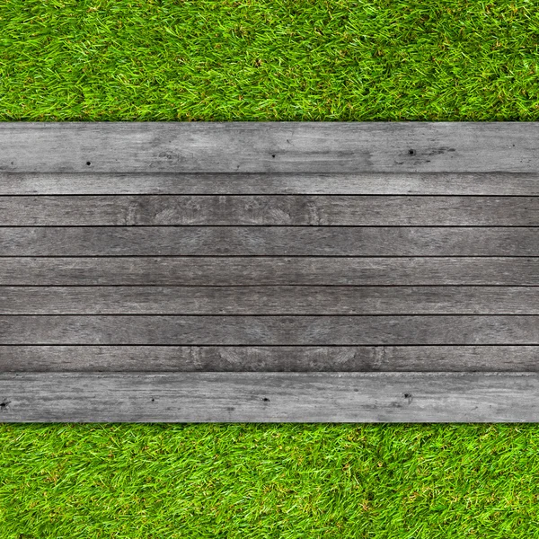 Wood texture on artificial grass background — Stock Photo, Image