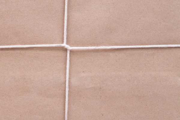 Background of white cardboard paper tied with twine