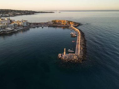 Yunanistan 'ın Girit kentindeki ünlü Chersonissos tatil beldesinin limanı gün batımında.