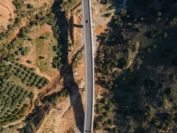 Aerial top view by drone of landscape with asphalt road.