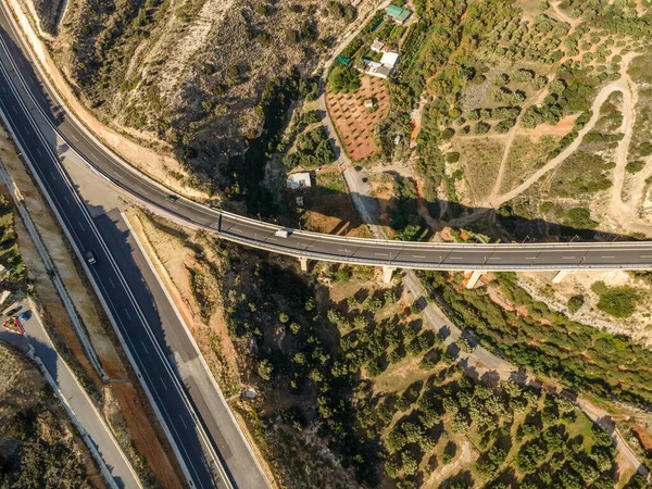 Aerial top view by drone of landscape with asphalt road.