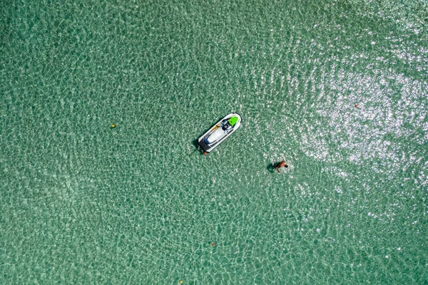 Aerial top view by drone of the sea with jet ski.