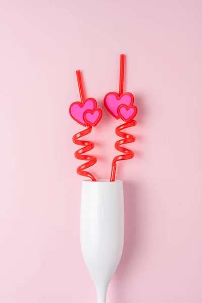 White Glass Champagne Hearts Straw Pink Background Love Minimal Concept — Zdjęcie stockowe
