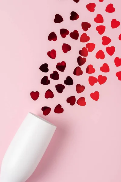 White Champagne Glass Splash Red Heart Shaped Confetti Pink Background — Zdjęcie stockowe