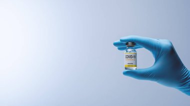 Doctor in blue latex gloves holding glass vial with medicine. Vaccination, immunization, treatment to Covid 19 Corona Virus infection. Healthcare And Medical concept.