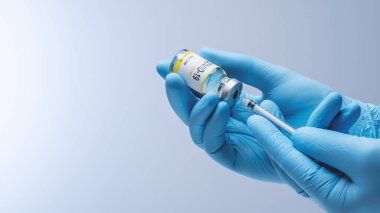 Doctor in blue latex gloves fill in syringe with vaccine from glass vial. Vaccination, immunization, treatment to Covid 19 Corona Virus infection. Healthcare And Medical concept.