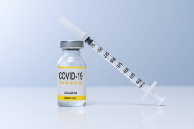 Vaccine in glass vial with syringe on a table. Vaccination, immunization, treatment to Covid 19 Corona Virus infection. Healthcare And Medical concept.