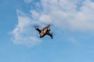 Kiev, Ukraine - April 26, 2021: A new DJI FPV drone is flying during a sunny day on sky background.