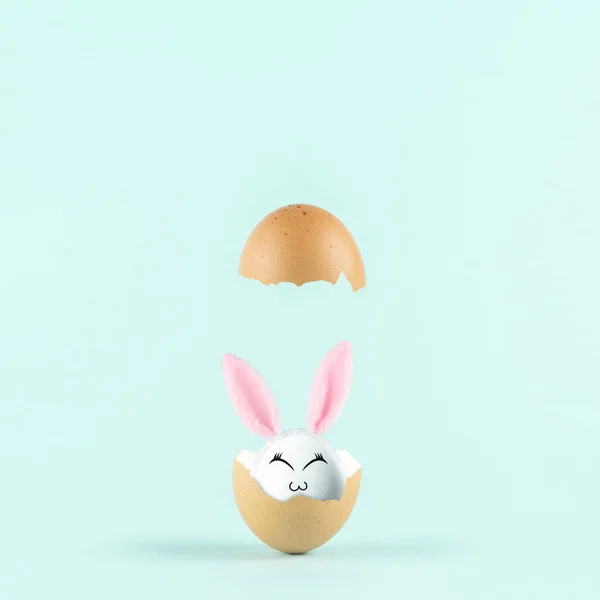 White Egg Rabbit Ears Cracked Eggshell Pastel Blue Background Easter — Stock fotografie