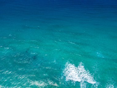 Aerial top view by drone of turquoise surface of the sea.