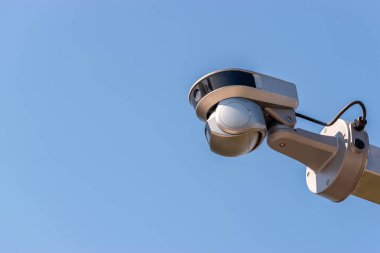 Street surveillance camera on sky background.