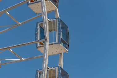 View of modern ferris wheel on background of blue sky in Kyiv city.