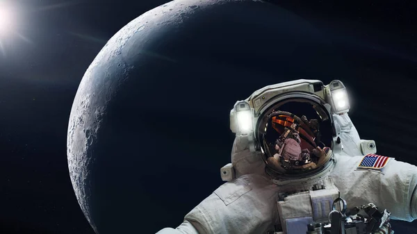 Cosmonaut in outer space on Moon planet background. Elements of this image furnished by NASA.