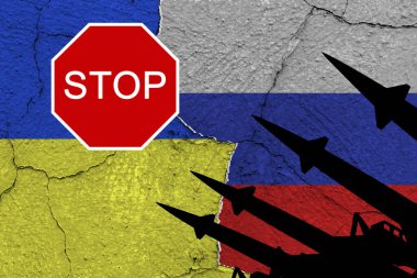 Ukraine and russia flags on old cracked wall with antiaircraft rockets silhouettes and sign 