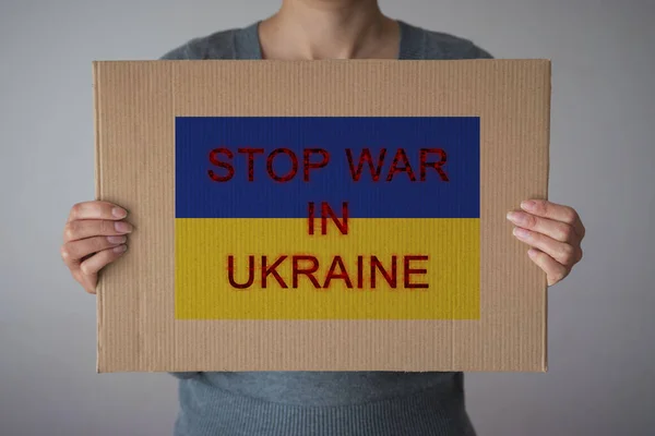 Woman Holds Paper Sign Stop War Ukraine Ukraine Flag Background — Stock Fotó