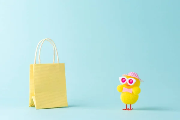 Creative minimal shopping concept made with cute chicken and shopping bag. Spring shopping layout.