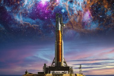 Orion uzay aracı nebula arka planında fırlatma rampasında. Ay Görevi. Güneş sistemini araştırmak için Artemis uzay programı. Bu görüntünün elementleri NASA tarafından desteklenmektedir. 