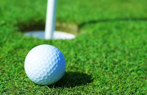 Golfball in front of the hole — Stock Photo, Image