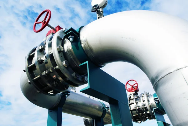 Industrial zone, Steel pipelines and valves against blue sky Stock Image