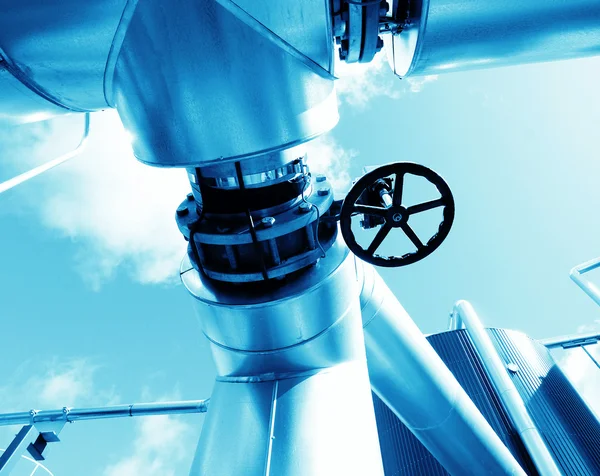 Industrial zone, Steel pipelines and valves in blue tones Stock Photo