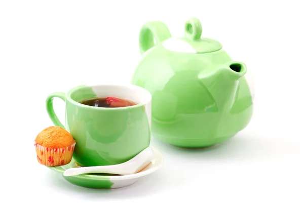 Tea being poured into tea cup isolated on a white background — Stock Photo, Image