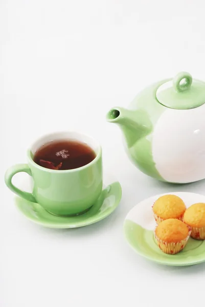 Tea being poured into tea cup isolated on a white background — Stock Photo, Image