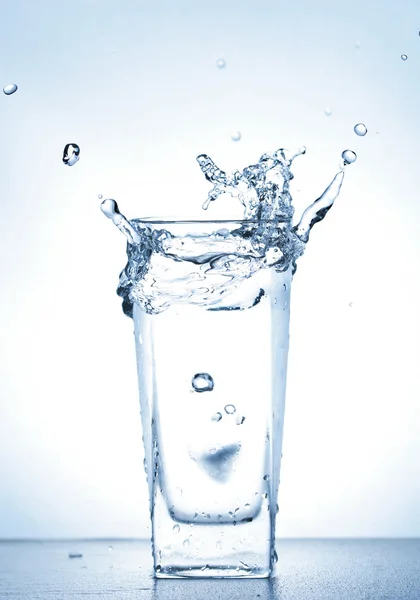 Water splash out of glass — Stock Photo, Image