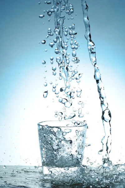 Water splash out of glass — Stock Photo, Image