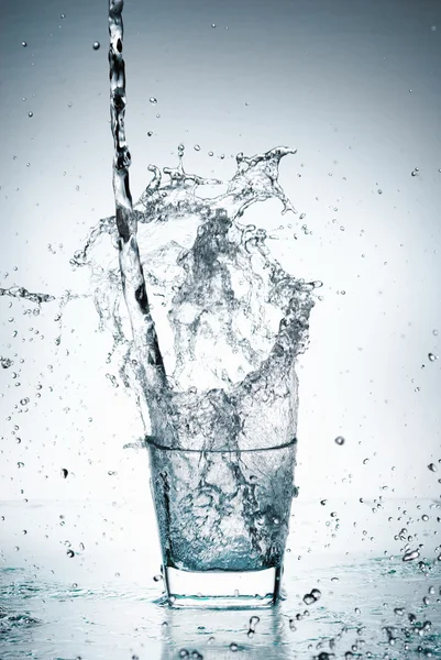 Water splash out of glass — Stock Photo, Image