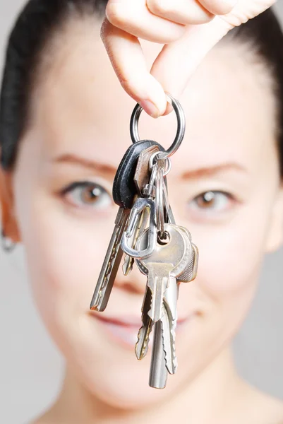 Young women with a key — Stock Photo, Image