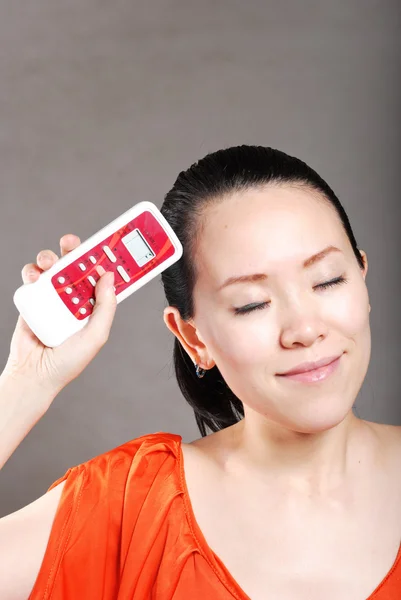 Young women with a remote control — Stock Photo, Image