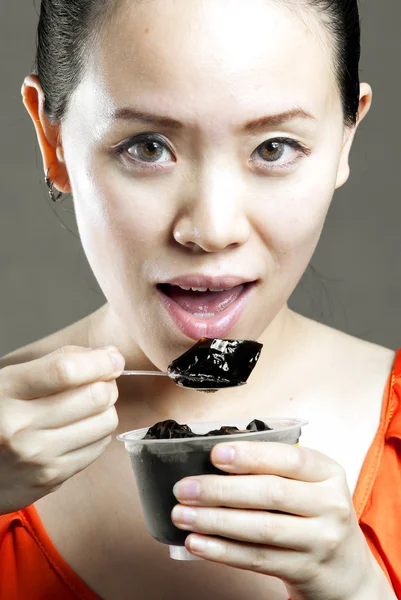 A beautiful woman eating food from a bowl — Stock Photo, Image